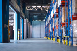 Empty manufacturing plant with tall racking storage