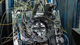 Die of a multi-slide hot chamber die casting machine