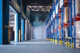 Empty manufacturing plant with tall racking storage