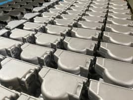 Aluminum metal parts organized in rows for shipment